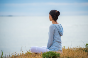 girl-sitting-by-water